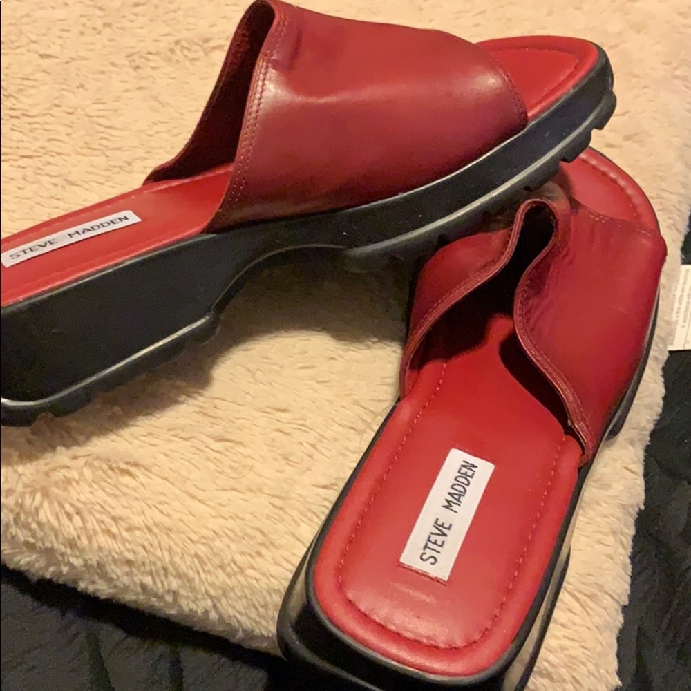A new pair red leather Steve Madden slides.